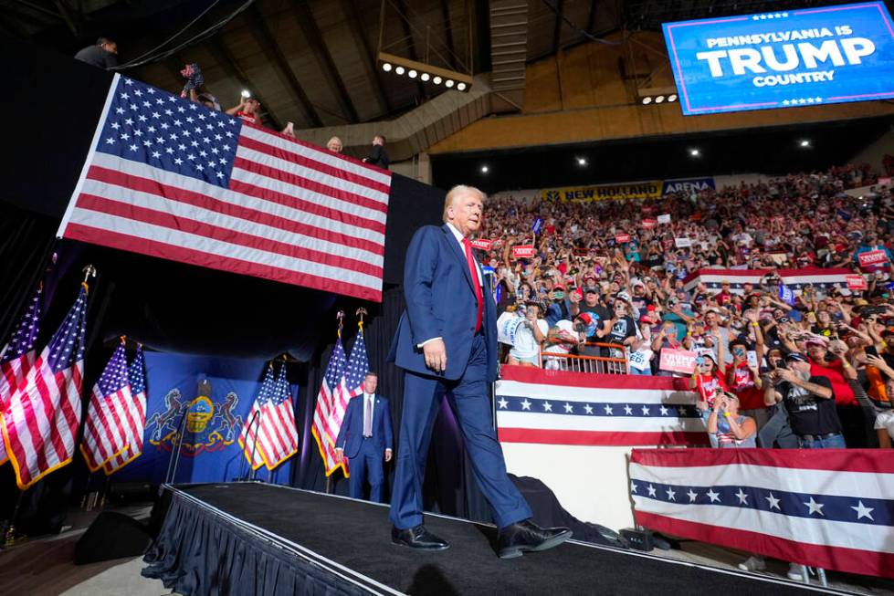 FILE - Republican presidential candidate former President Donald Trump arrives to speak at a ca ...