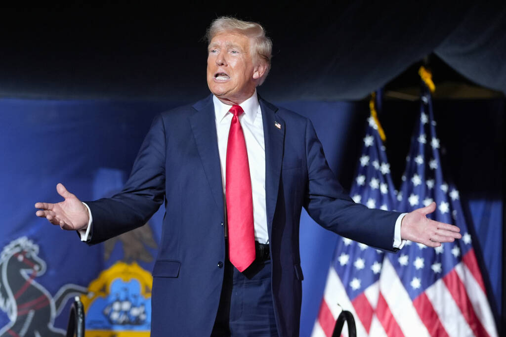 FILE - Republican presidential candidate former President Donald Trump gestures to the crowd as ...