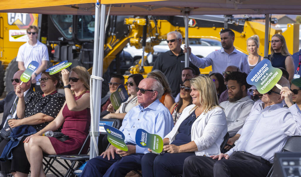 Participants stay shaded as Henderson Mayor Michelle Romero speaks while joined by other dignit ...