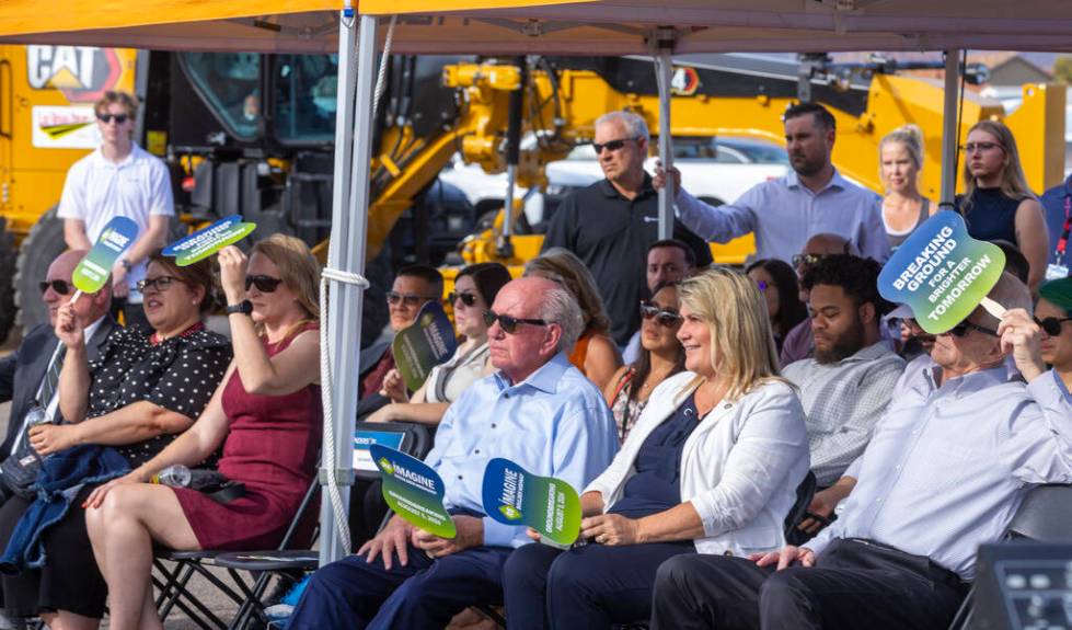 Participants stay shaded as Henderson Mayor Michelle Romero speaks while joined by other dignit ...