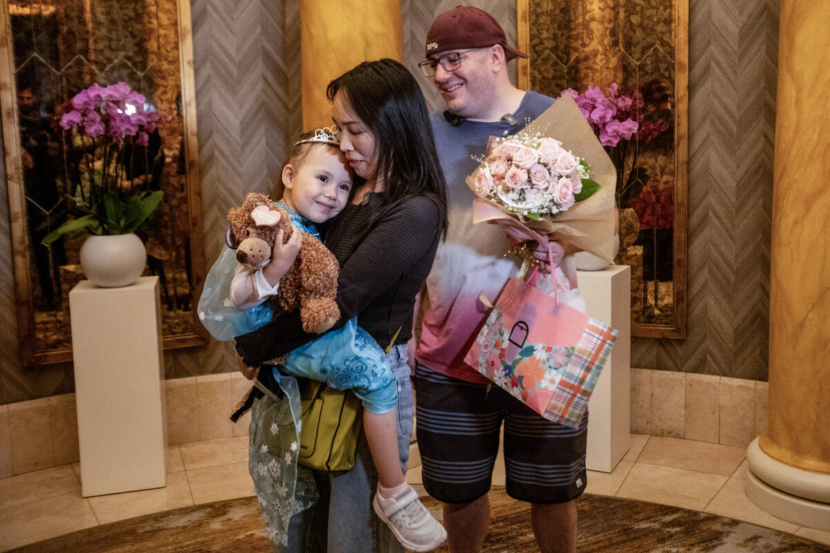 Samantha Buckley, 5, left, her mother June Chen, center, and father William Buckley, right, are ...