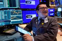 Trader Drew Cohen works on the floor of the New York Stock Exchange, Tuesday, Aug. 6, 2024.(AP ...