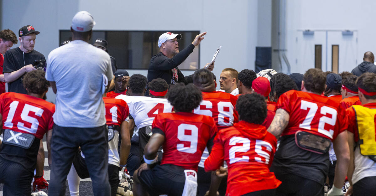 UNLV head coach Barry Odom talks with his players during football practice at the Intermountain ...