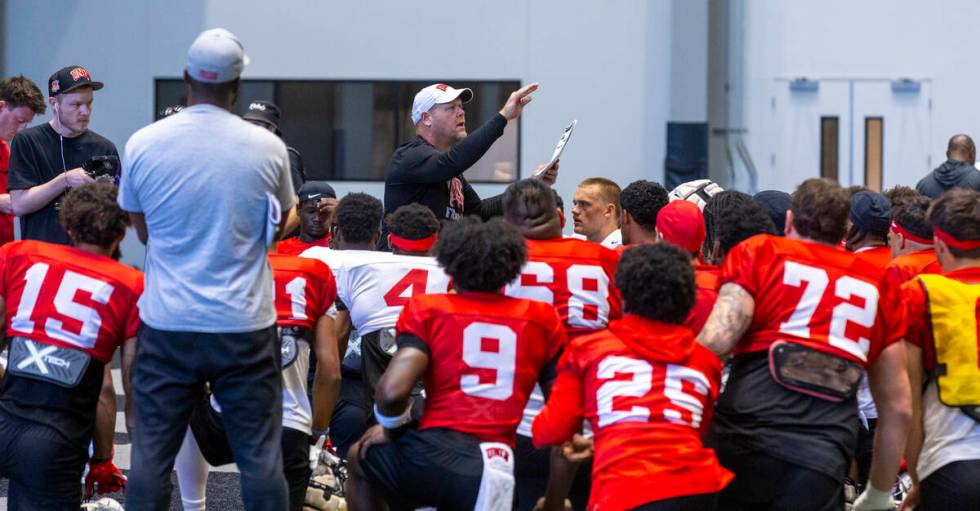 UNLV head coach Barry Odom talks with his players during football practice at the Intermountain ...