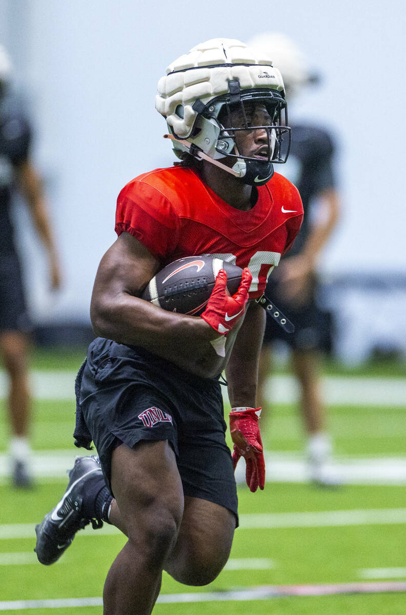 UNLV running back Kylin James (20) heads up the field during football practice at the Intermoun ...