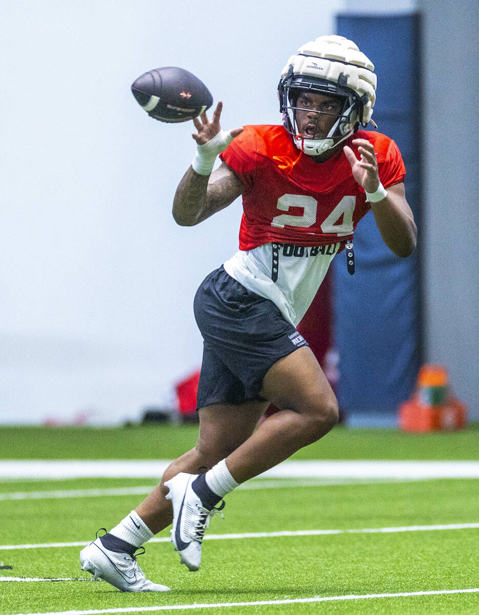 UNLV running back Darrien Jones (24) looks in a pass during football practice at the Intermount ...