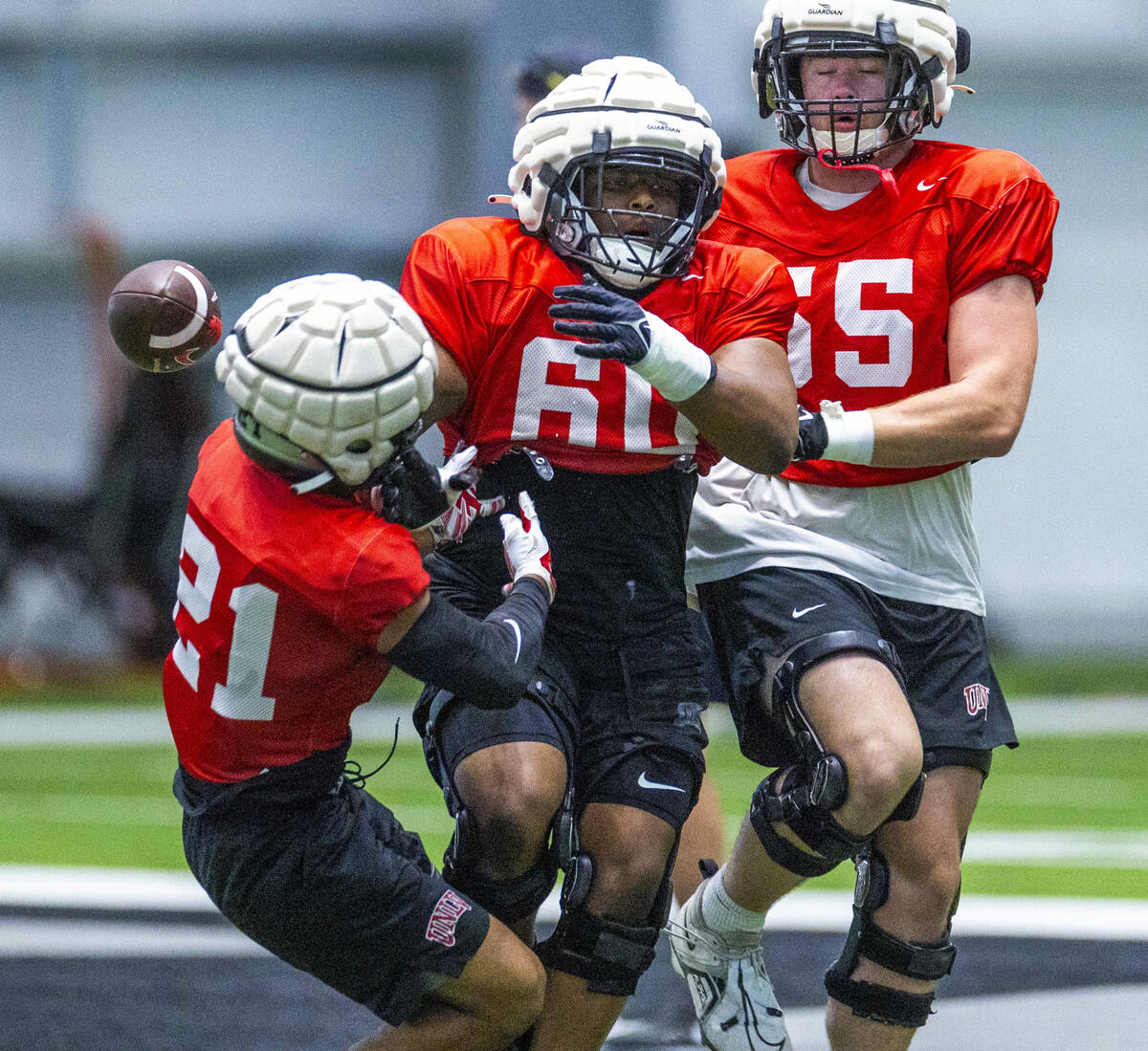 UNLV wide receiver Jacob De Jesus (21) collides with offensive lineman Sammy Norris (60) on a d ...