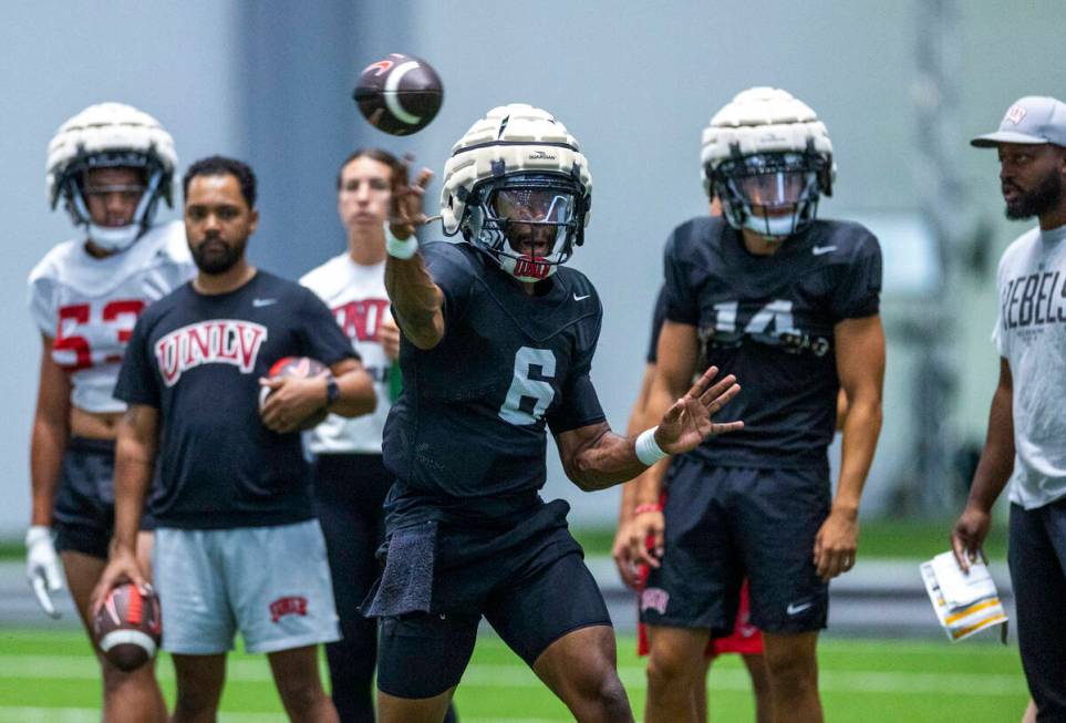 UNLV quarterback Hajj-Malik Williams (6) passes to a receiver during football practice at the I ...