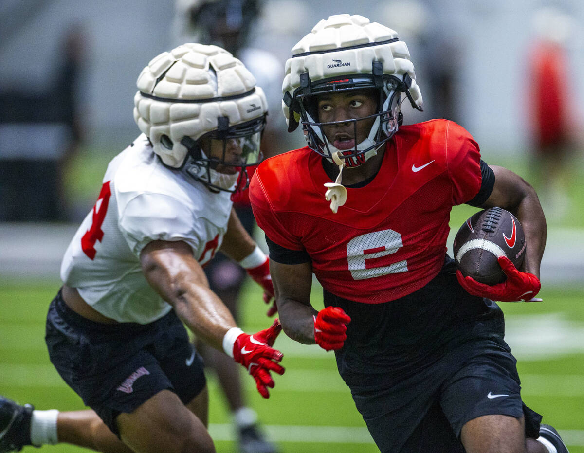 UNLV wide receiver Damien McDaniel (2) works to evade a tackle by linebacker Tyray O'Dell (34) ...