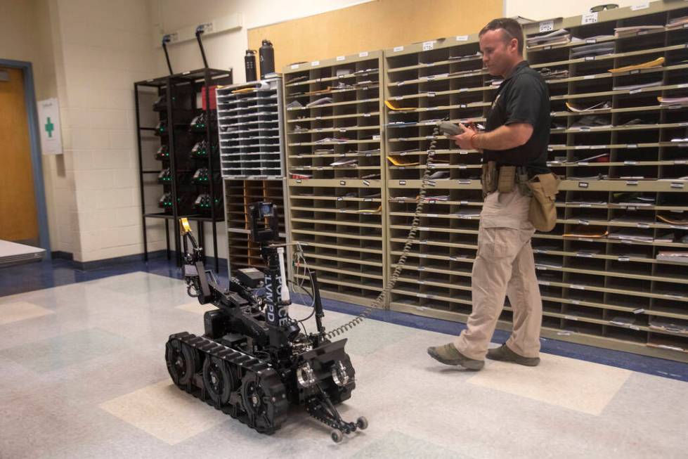 Skyler Lee, of the Las Vegas Metro Police Department ARMOR division, controls the T5 robot to d ...