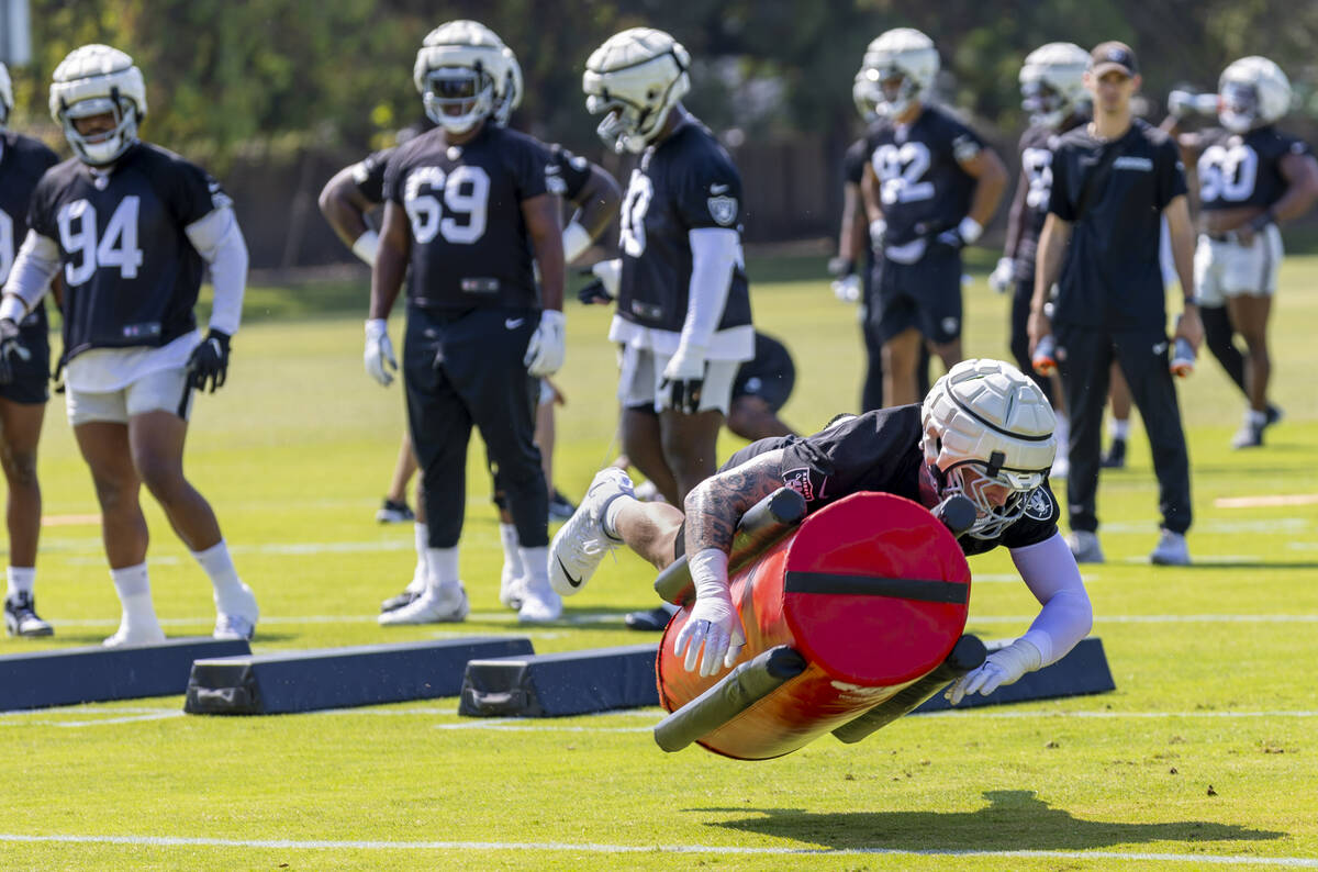 Raiders defensive end Maxx Crosby (98) tackles a dummy during the first day of Raiders training ...