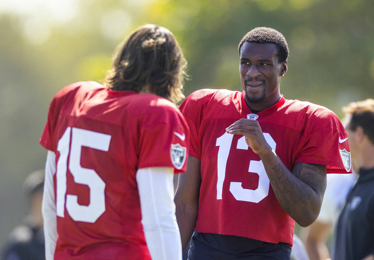 Raiders quarterback Anthony Brown Jr. (13) chats with quarterback Gardner Minshew (15) during t ...