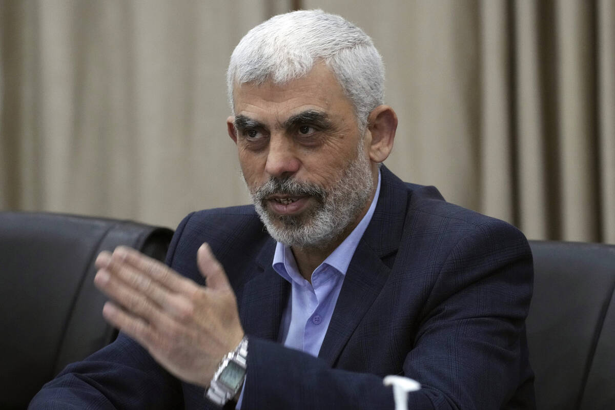 Yehia Sinwar, head of Hamas in Gaza, greets his supporters during a meeting with leaders of Pal ...