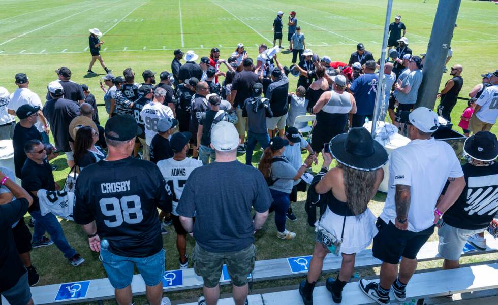 Raiders players take time to sign autographs for fans following the third day of training camp ...