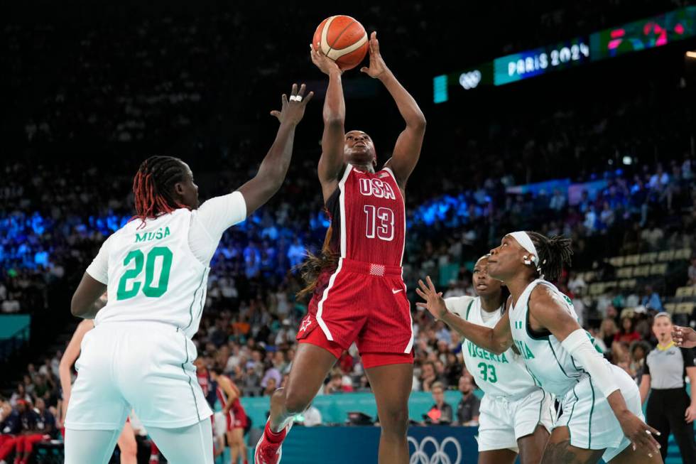 United States' Jackie Young (13) shoots between Murjanatu Musa (20) and Ezinne Kalu (23), of Ni ...