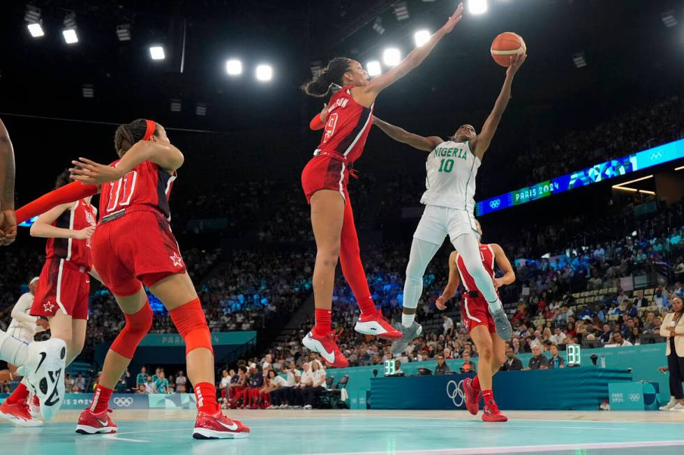 Promise Amukamara (10), of Nigeria, shoots over United States' A'ja Wilson (9) during a women's ...