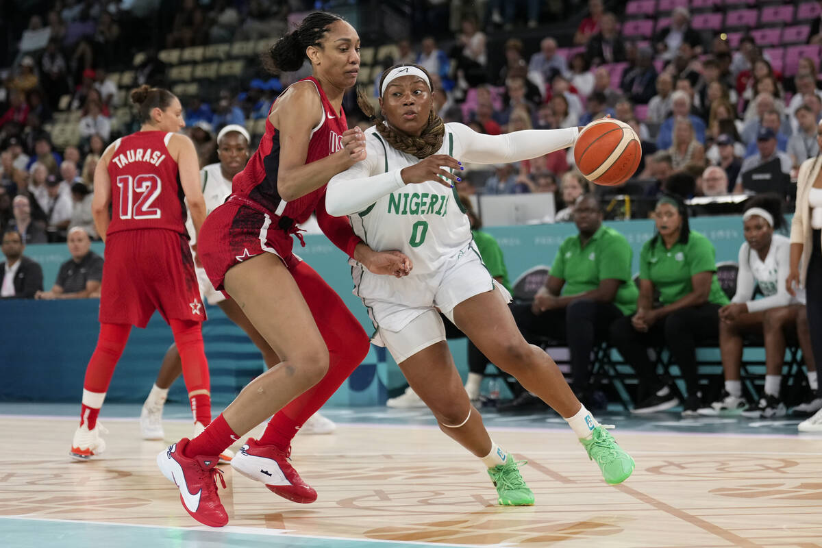 Amy Okonkwo (0), of Nigeria, drives on United States' A'ja Wilson (9) during a women's quarterf ...