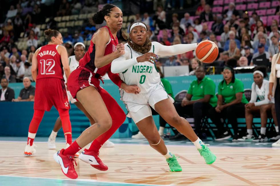 Amy Okonkwo (0), of Nigeria, drives on United States' A'ja Wilson (9) during a women's quarterf ...