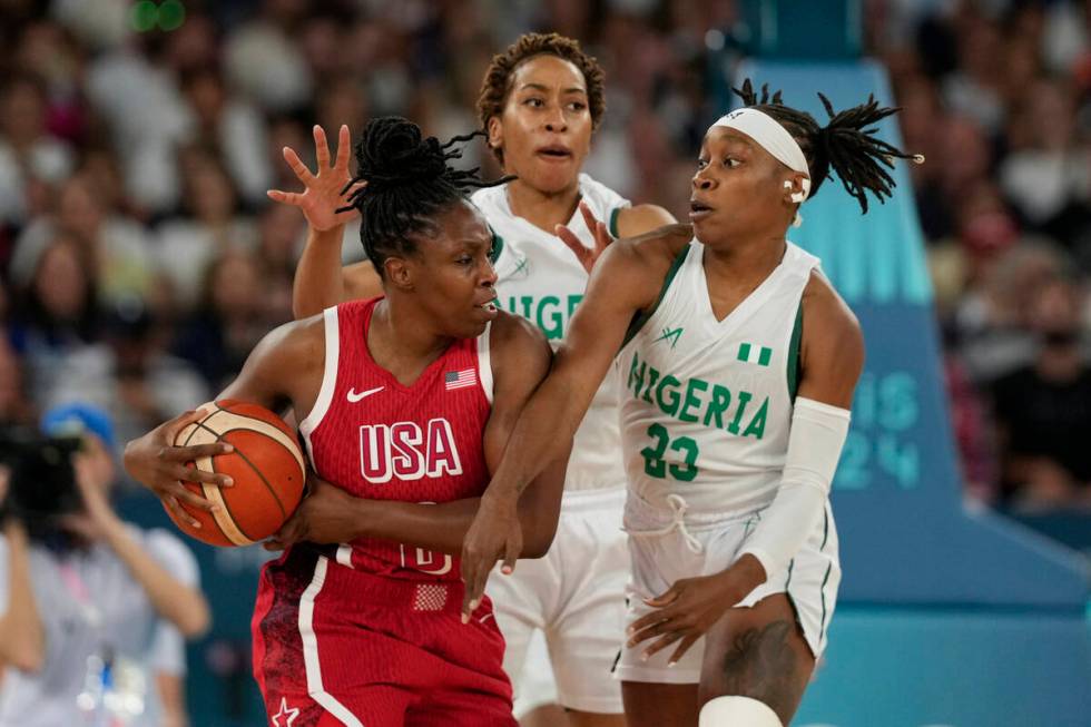 Pallas Kunayi Akpanah, left, and Ezinne Kalu (23), of Nigeria, defend United States' Chelsea Gr ...