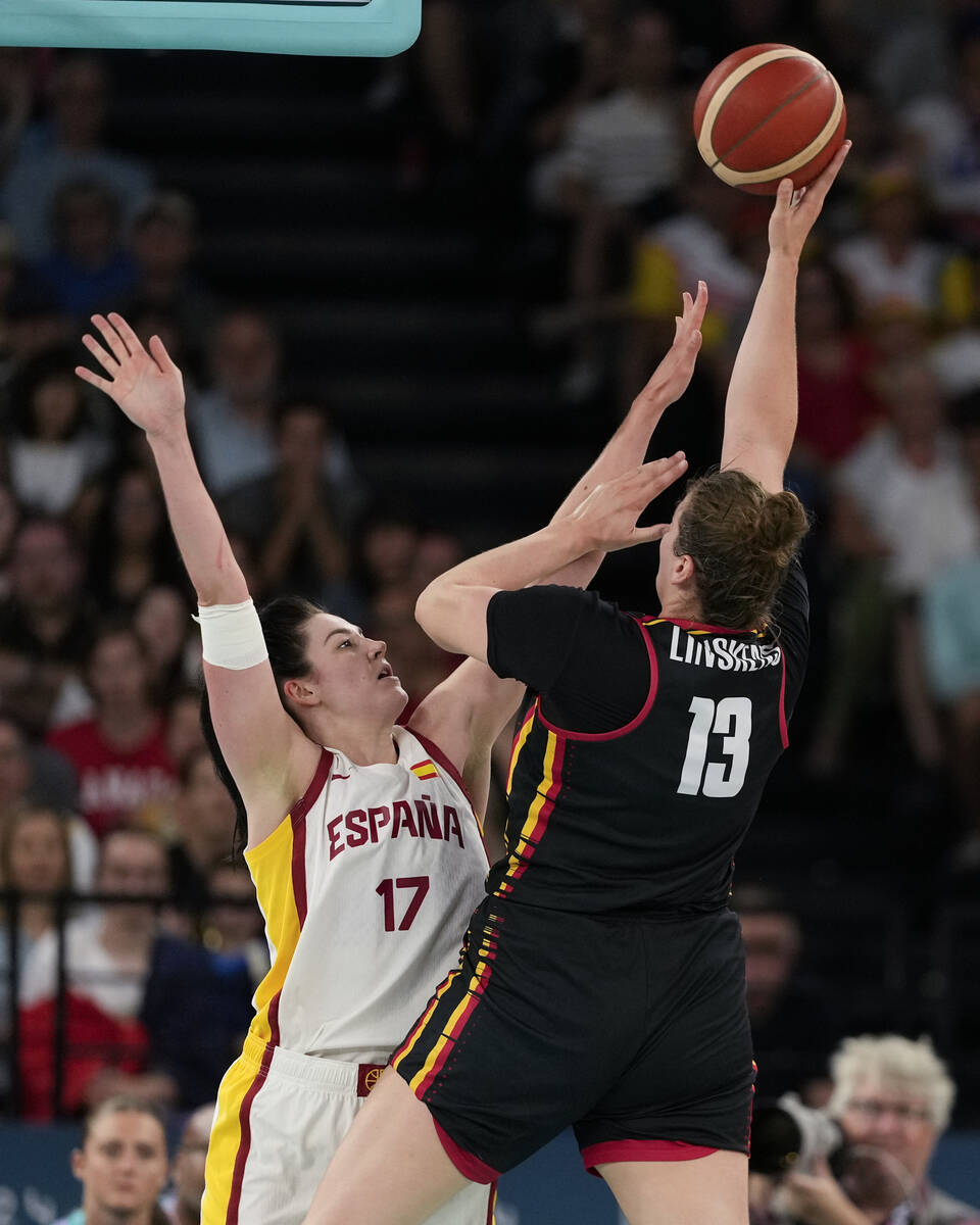 Kyara Linskens (13), of Belgium, shoots over Megan Gustafson (17), of Spain, during a women's q ...