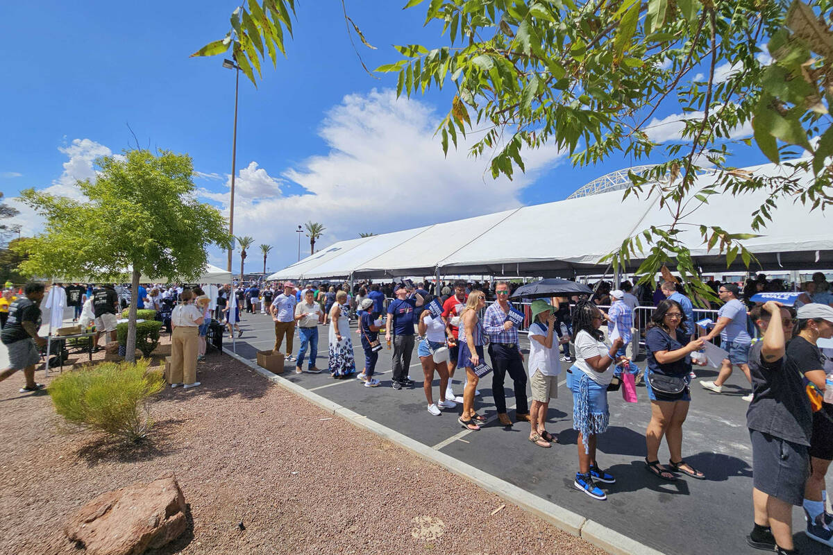 Supporters wait in line to attend the rally with Vice President Kamala Harris and her running m ...