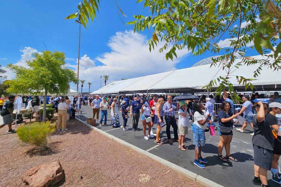 Supporters wait in line to attend the rally with Vice President Kamala Harris and her running m ...