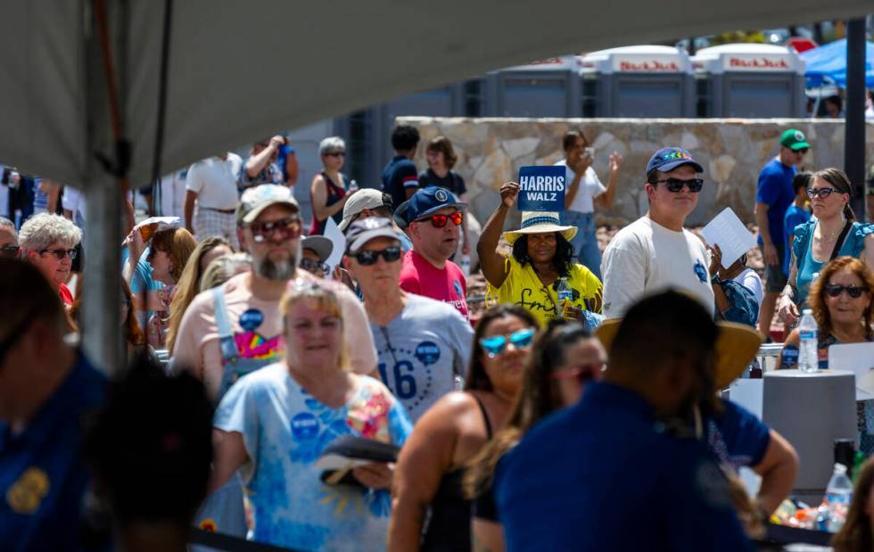 Attendees line up around the building to enter as Vice President Kamala Harris and her running ...