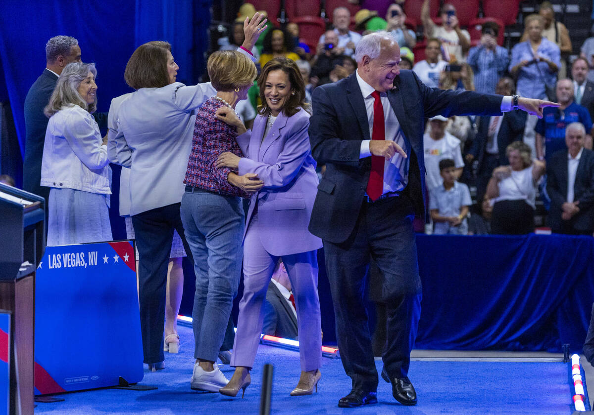 Vice President Kamala Harris and her running mate, Minnesota Gov. Tim Walz, leave the delegatio ...