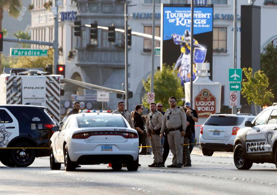 Las Vegas police investigate a shooting involving an officer in the area of East Harmon Avenue ...