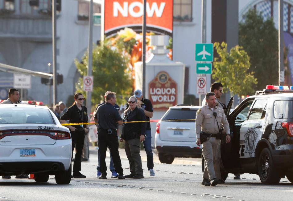 Las Vegas police investigate a shooting involving an officer in the area of East Harmon Avenue ...