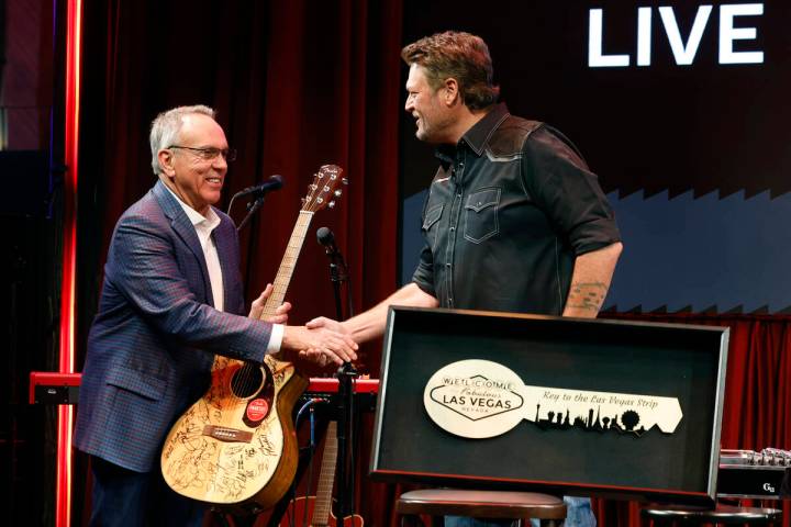 Commissioner James Gibson, left, shakes hands with country singer and songwriter Blake Shelton, ...