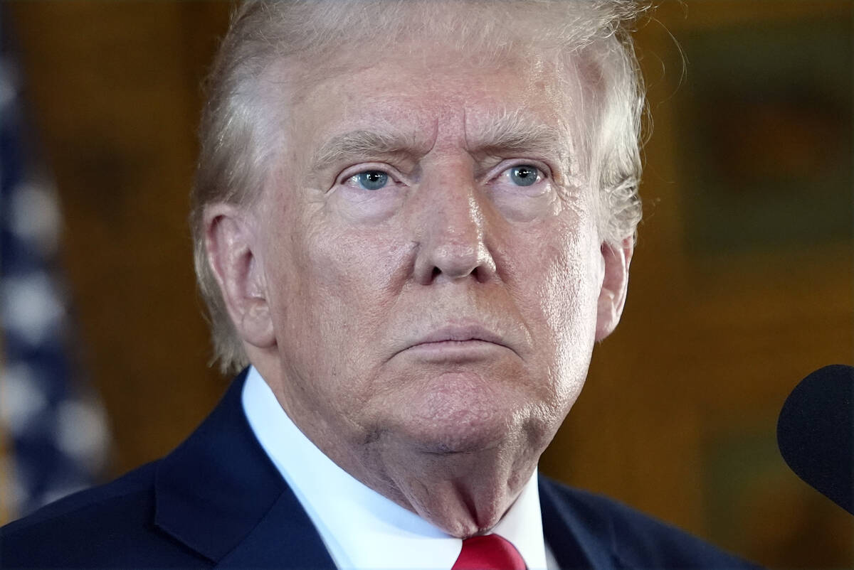 Republican presidential nominee former President Donald Trump listens to a question as he speak ...