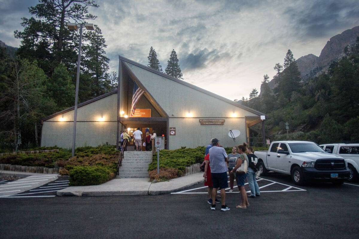 Members of the Mount Charleston community talk outside the Mount Charleston Library after an op ...