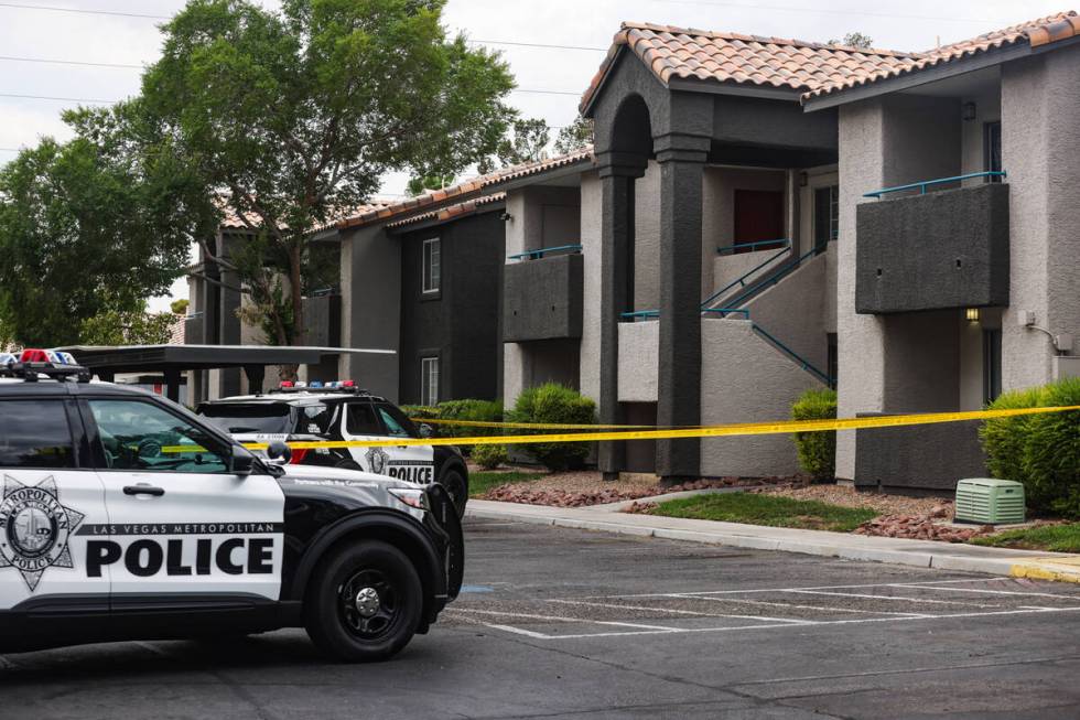 Police at the scene where one person died after a shooting at an apartment complex in west Las ...