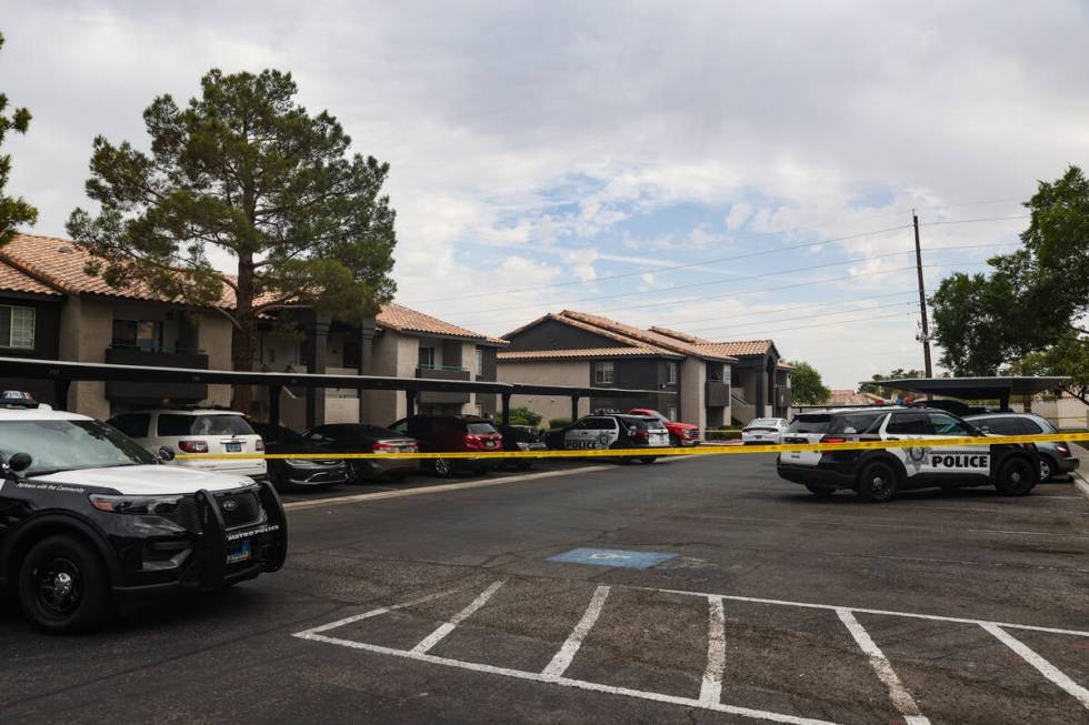 Police at the scene where one person died after a shooting at an apartment complex in west Las ...