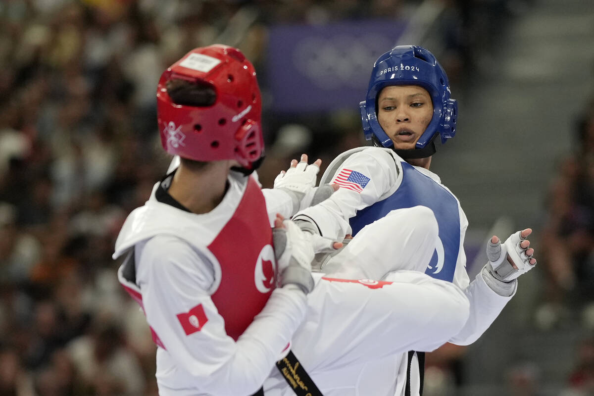 United States' Faith Dillon (in blue) competes with Tunisia's Chaima Toumi in a women's 57kg Ta ...