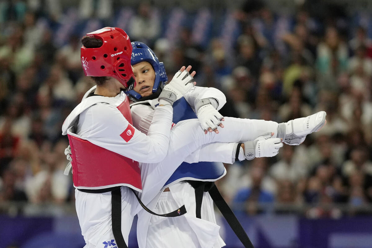 United States' Faith Dillon (in blue) competes with Tunisia's Chaima Toumi in a women's 57kg Ta ...