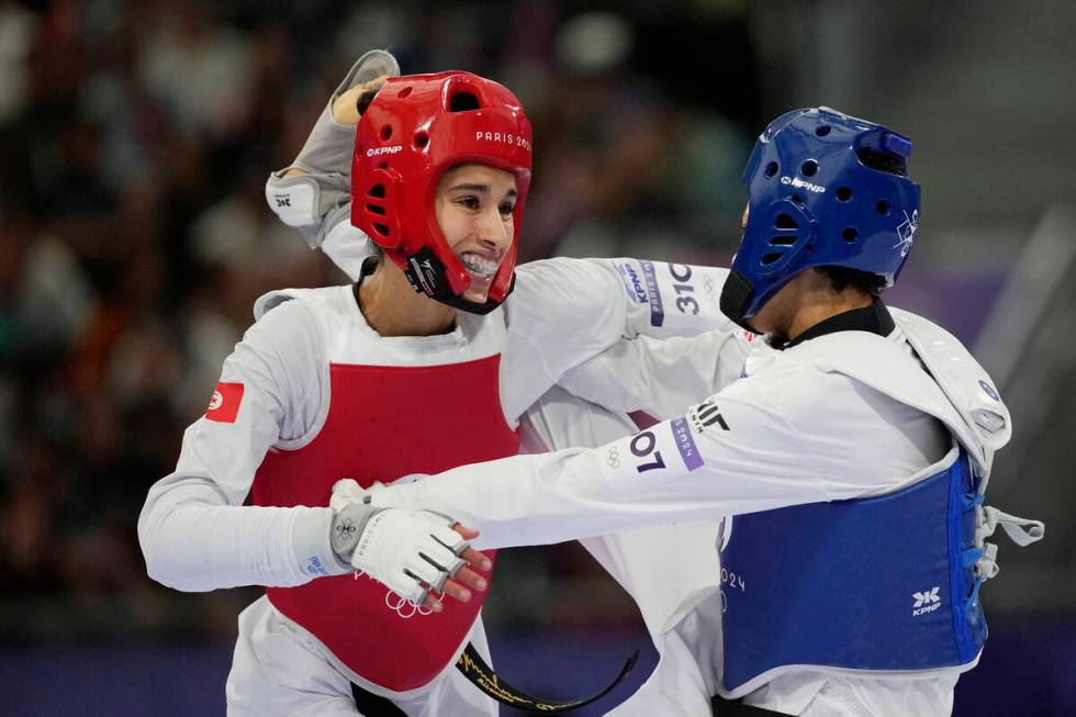 United States' Faith Dillon (in blue) competes with Tunisia's Chaima Toumi in a women's 57kg ta ...