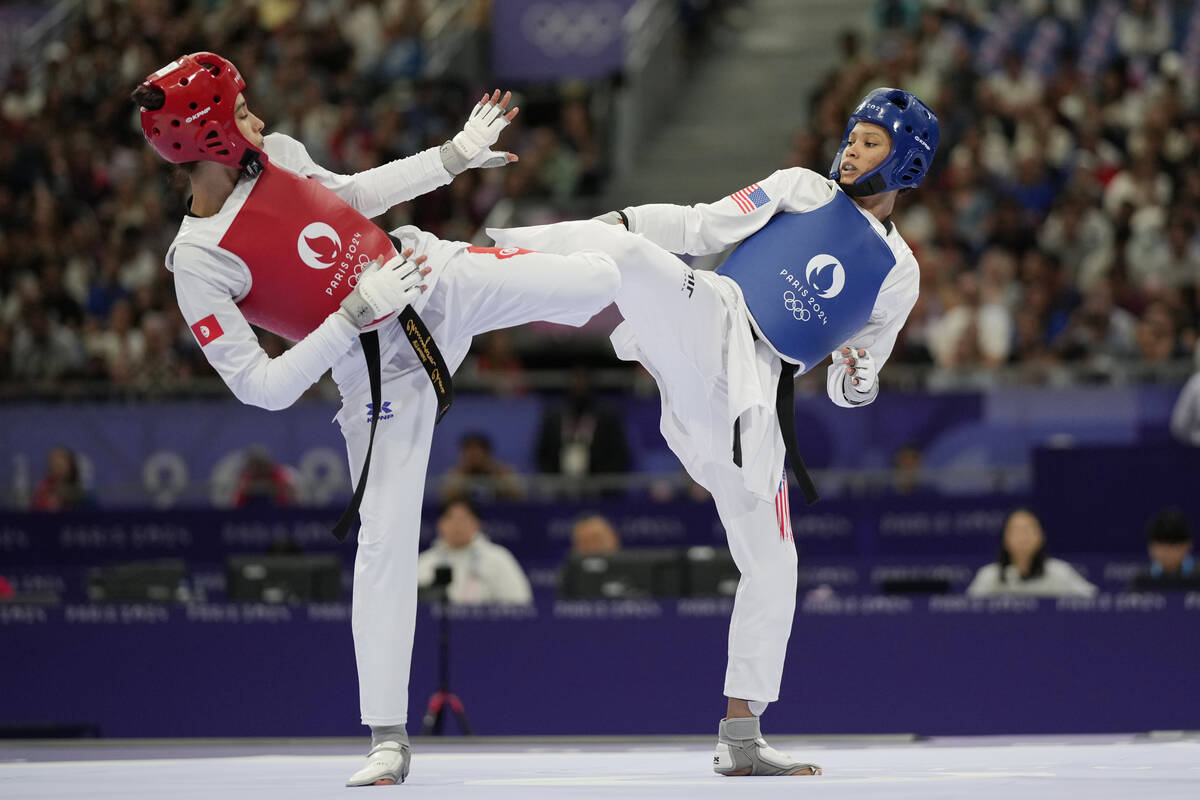 United States' Faith Dillon (in blue) competes with Tunisia's Chaima Toumi in a women's 57kg Ta ...