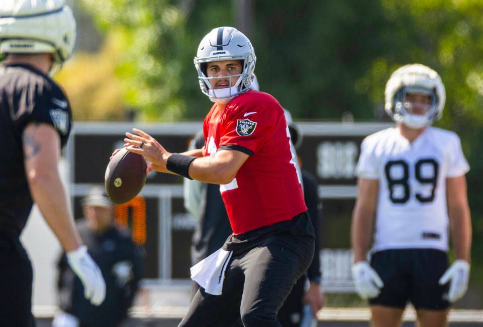 Raiders quarterback Aidan O'Connell (12) looks for a receiver during the third day of Raiders t ...