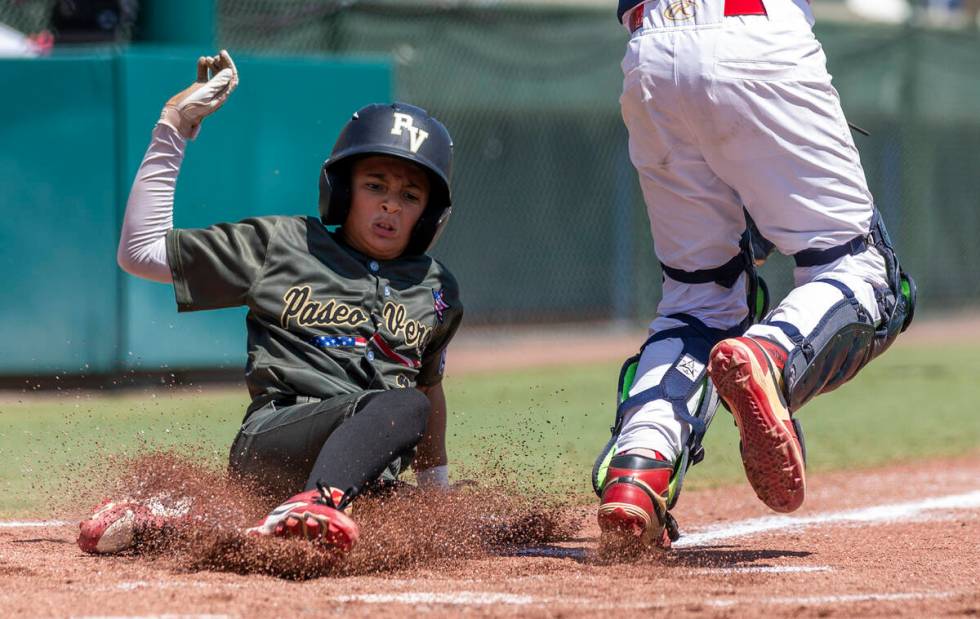 Nevada's Russell McGee (2) slides safely home for the first run against Utah during the first i ...