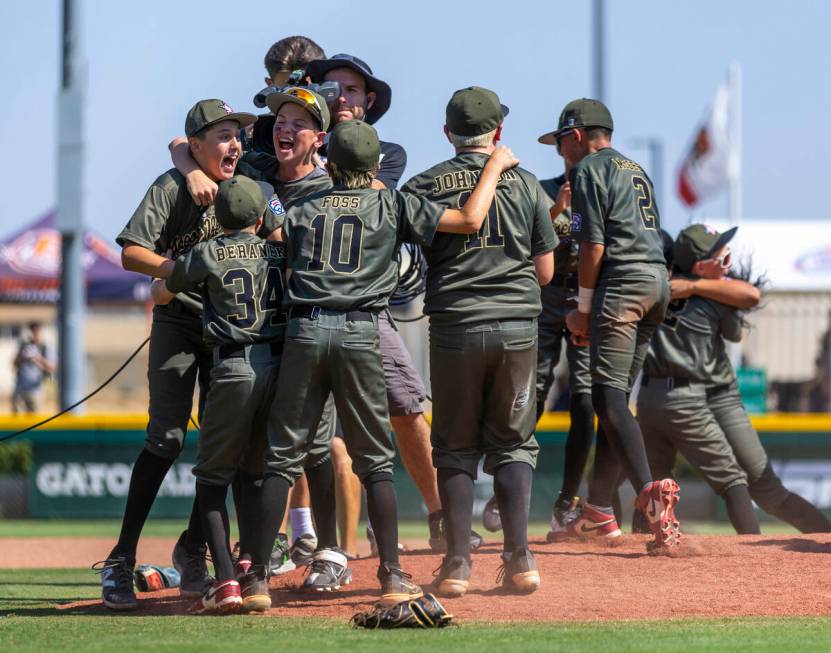 Nevada players celebrate their 2-0 win over Utah in the Mountain Regional final baseball game o ...