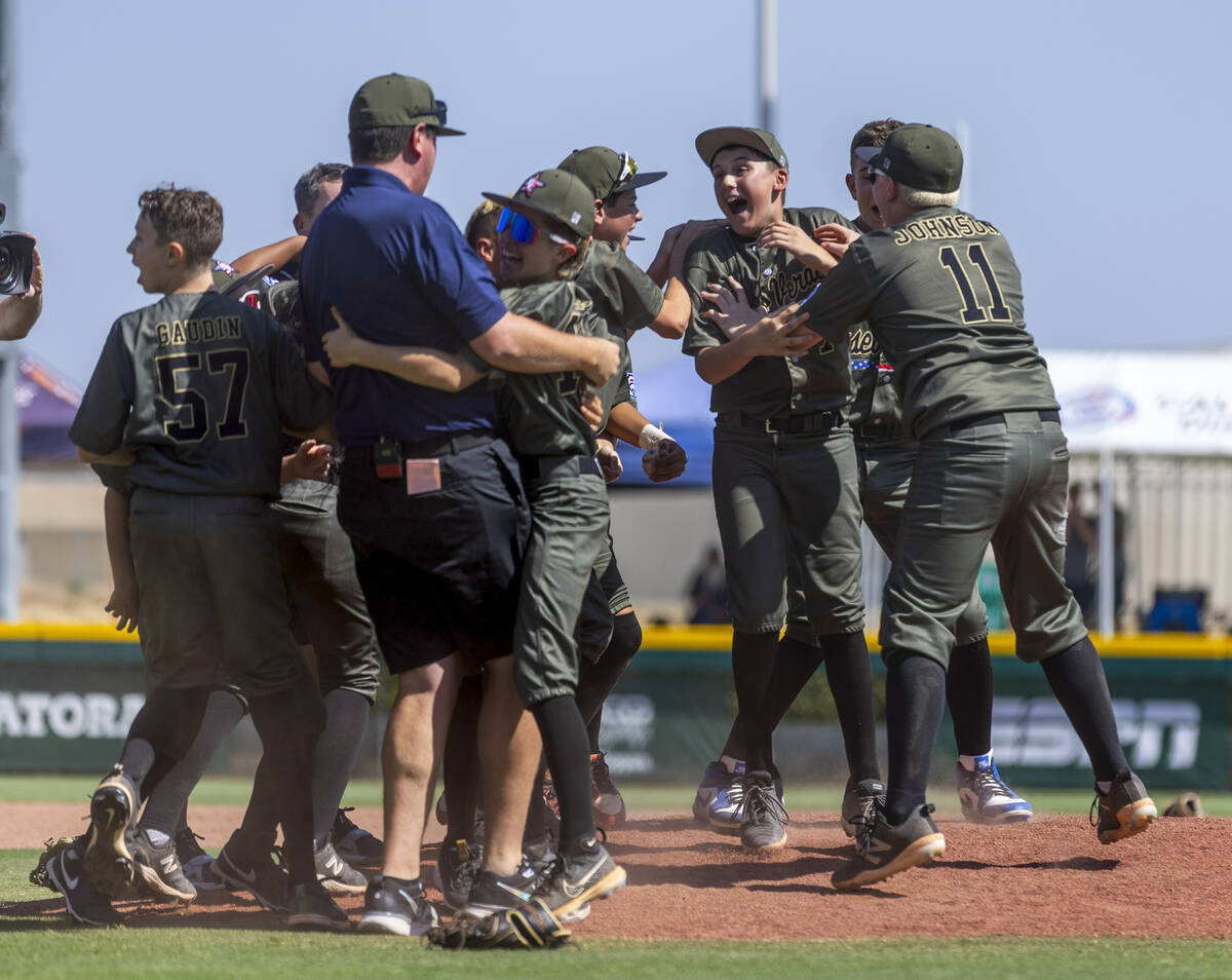 Nevada players celebrate with manager Adam Johnson after their 2-0 win over Utah in the Mountai ...