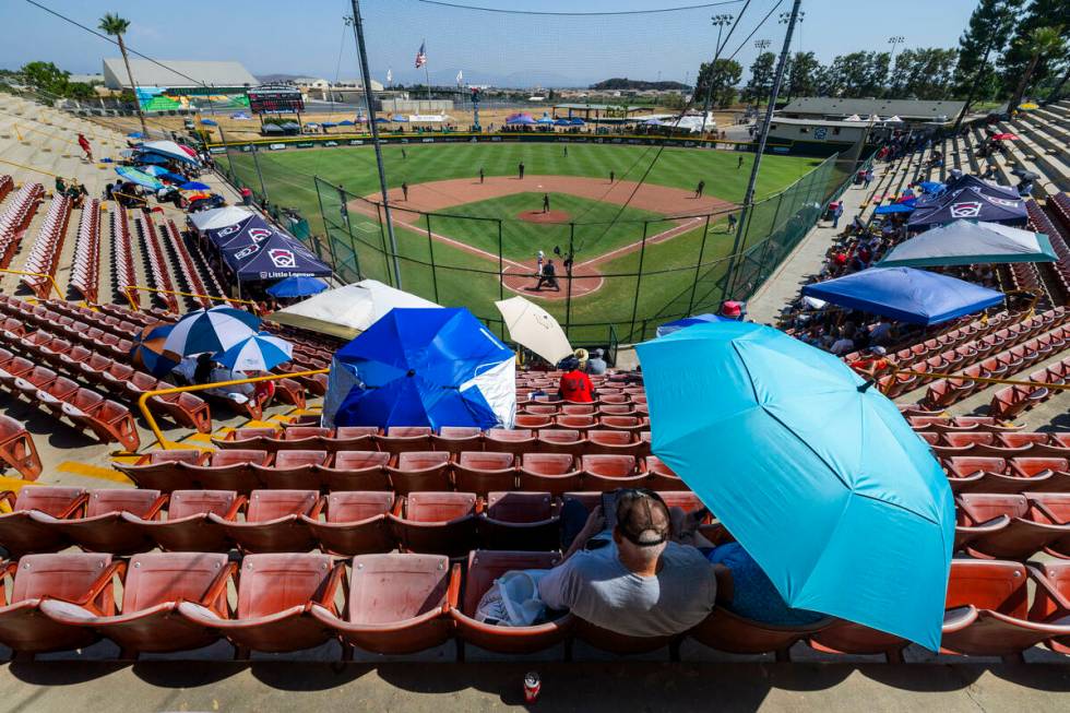 Fans do their best to stay cool in the hot stands as Nevada dominates Utah during the sixth inn ...