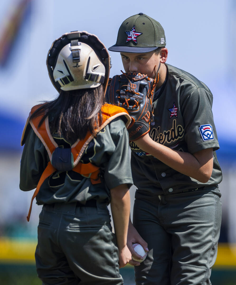 Nevada pitcher Wyatt Erickson (7) confers with catcher Parker Soranaka (23) on the mound agains ...