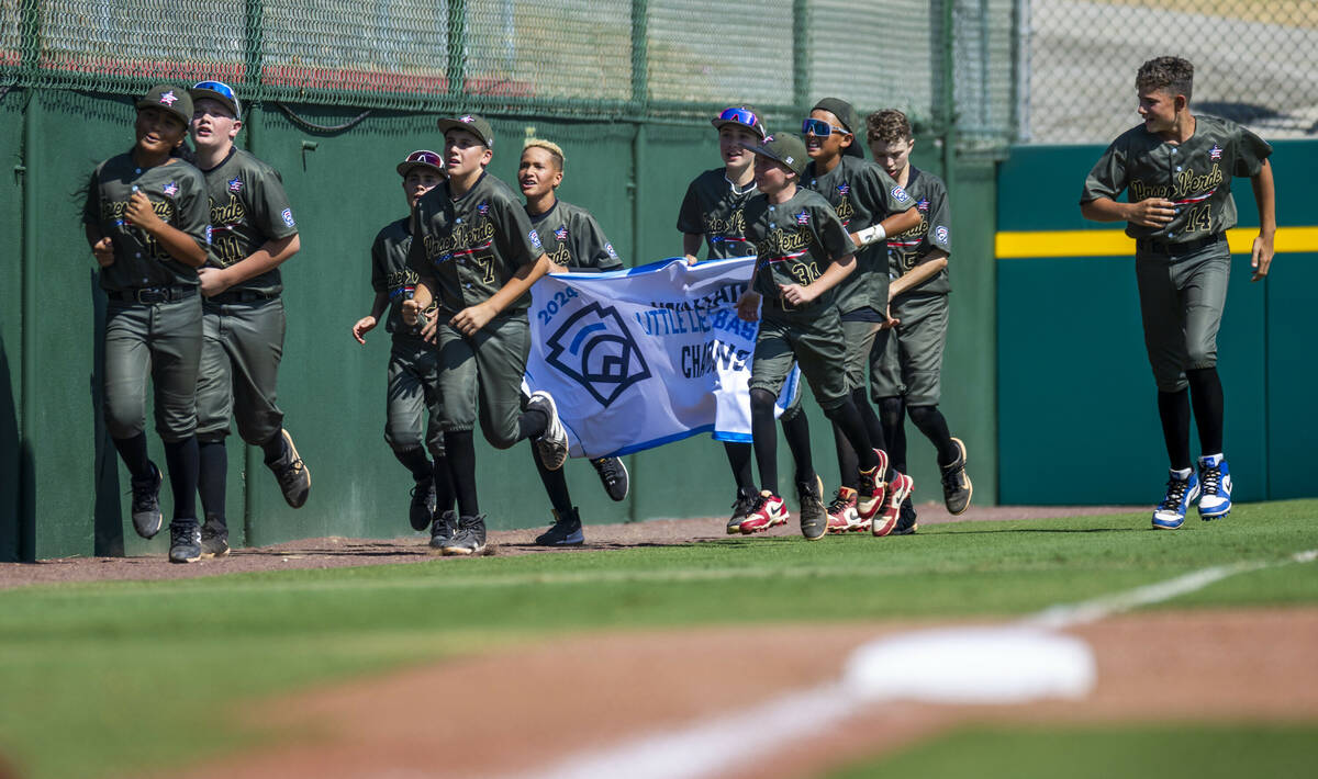 Nevada players run on the field with their winning banner after defeating Utah 2-0 in the Mount ...