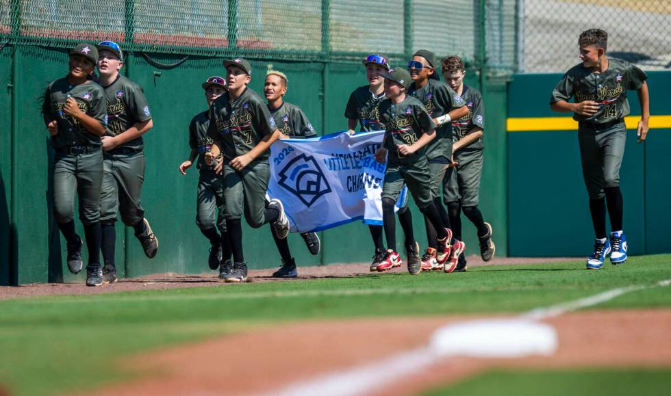 Nevada players run on the field with their winning banner after defeating Utah 2-0 in the Mount ...