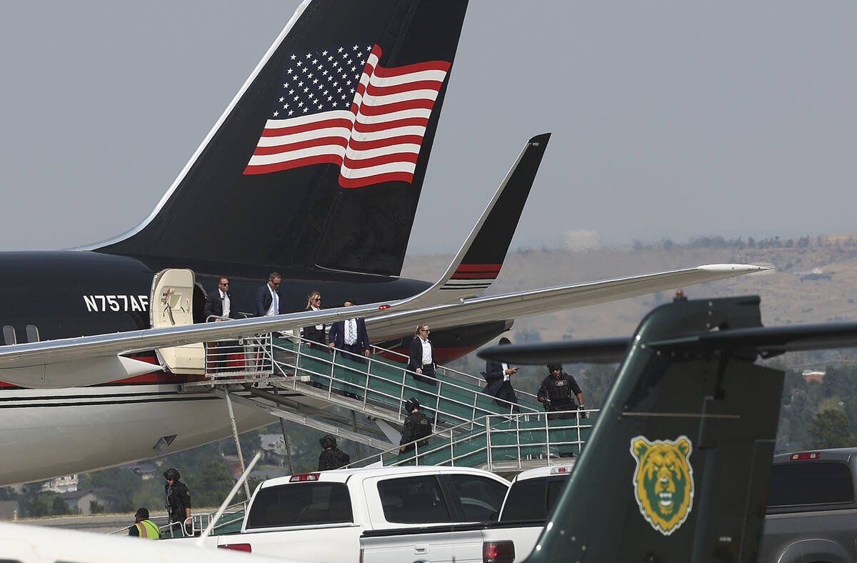 Members of former President Donald Trump's team disembark from his Boeing 757 after arriving at ...