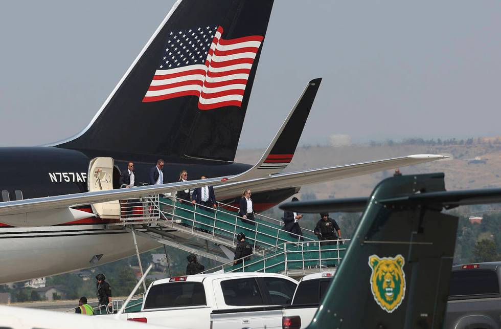 Members of former President Donald Trump's team disembark from his Boeing 757 after arriving at ...