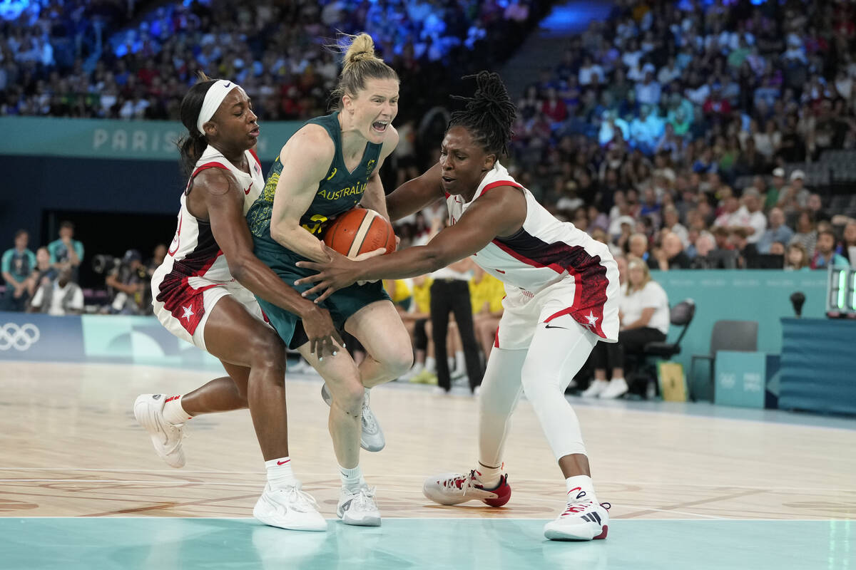 Sami Whitcomb (32), of Australia, drives under the pressure from United States' Jackie Young (1 ...